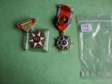 three medals and a medal on a green table