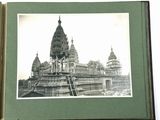 an old photo of a large building in the middle of the day