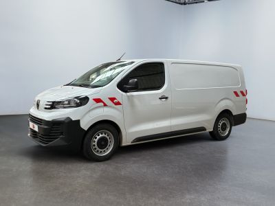 the white van is parked in a large room with a black floor