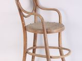 an image of a wooden chair with a woven seat on a white background
