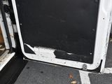a broken door on the side of a building