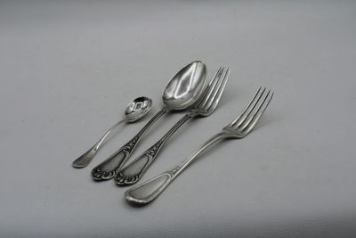 a spoon, fork, and spoon rest on a table
