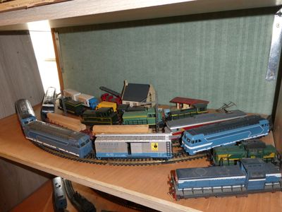 a lot of toy trains on a shelf in a room