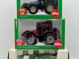 two boxes of toy tractors are stacked on top of each other