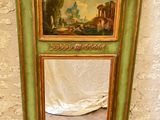 a green cabinet with a painting on the top of it