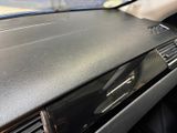 a close up of a car ' s dashboard with a remote control