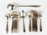 a lot of silver spoons and forks on a white table
