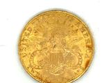 an image of a gold coin sitting on top of a white surface
