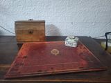 an old book sitting on a table next to a small box