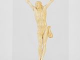 une sculpture représentant Jésus sur la croix, posée sur une surface claire