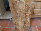 a tree stump sitting on the floor in a kitchen