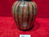 a vase that is sitting on a red surface