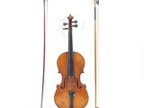 a violin that is sitting next to a bow
