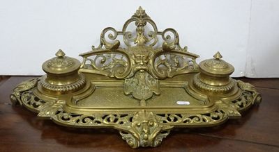 an image of a gold plate with a pen and inkwell on it