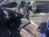 the interior of a car with the door open and the driver ' s seat down