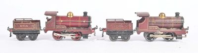 three toy trains sitting side by side on a white surface