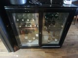 a glass door with bottles of wine inside of it
