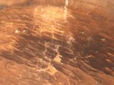 a close up of a wooden table with a brown stain on it