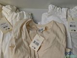 a white shirt and a white shirt with a tag on it