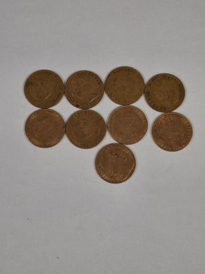 a lot of coins that are on a white surface