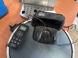 a remote control and a radio on a table