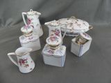 five pieces of porcelain tea and coffee set on a table