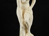 an image of a statue of a woman sitting on top of a table