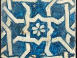 a blue and white tile with a star design on it