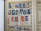 an open book with stamps on it sitting on a table