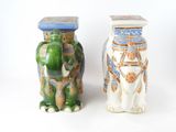 two vases sitting next to each other on a white surface
