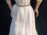 a doll that is standing on a black surface