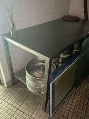 a small table with a keg on it in a kitchen