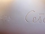a close up of a white vase with a name on it