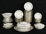 a lot of plates and bowls on the table