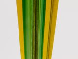 a green and yellow vase sitting on a white table