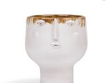 a white vase with a brown face on it