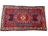 a red and blue rug on a white background