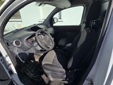 the interior of a car with the door open and the driver ' s seat down