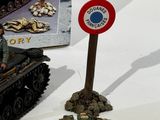 a toy tank and a sign on a table