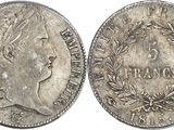 a silver coin with a woman ' s head and laurels on it