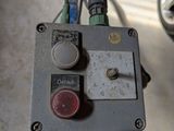 an image of a close up of a control panel with a car in the background