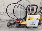 a machine that is sitting on the ground next to some hoses