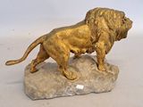 a statue of a lion on a rock on a white surface
