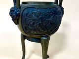 an image of a blue vase with a lion head on it