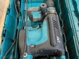 a blue box with a drill in it sitting on a pallet
