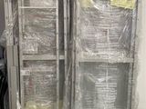 two metal shelvings that are wrapped in plastic