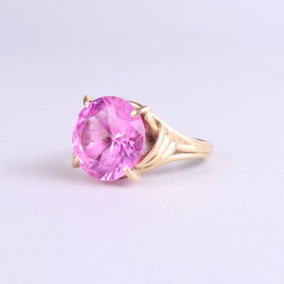 an image of a close up of a pink ring on a white surface