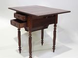 a small wooden table with a drawer underneath it