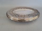 an antique silver plate with a decorative design on the rim