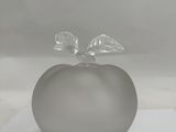 a glass apple with a leaf on top of it